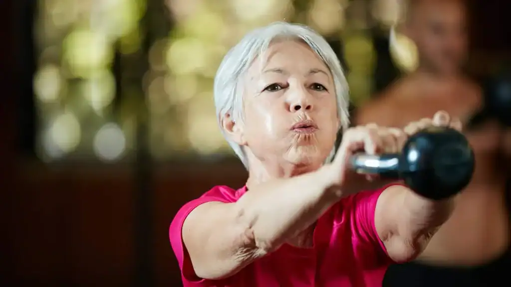 Toning Arms After 60: Empowering Womens Fitness Through Effective Weight Training 1 Older woman doing weight training Knutsford to help her strength and longevity
